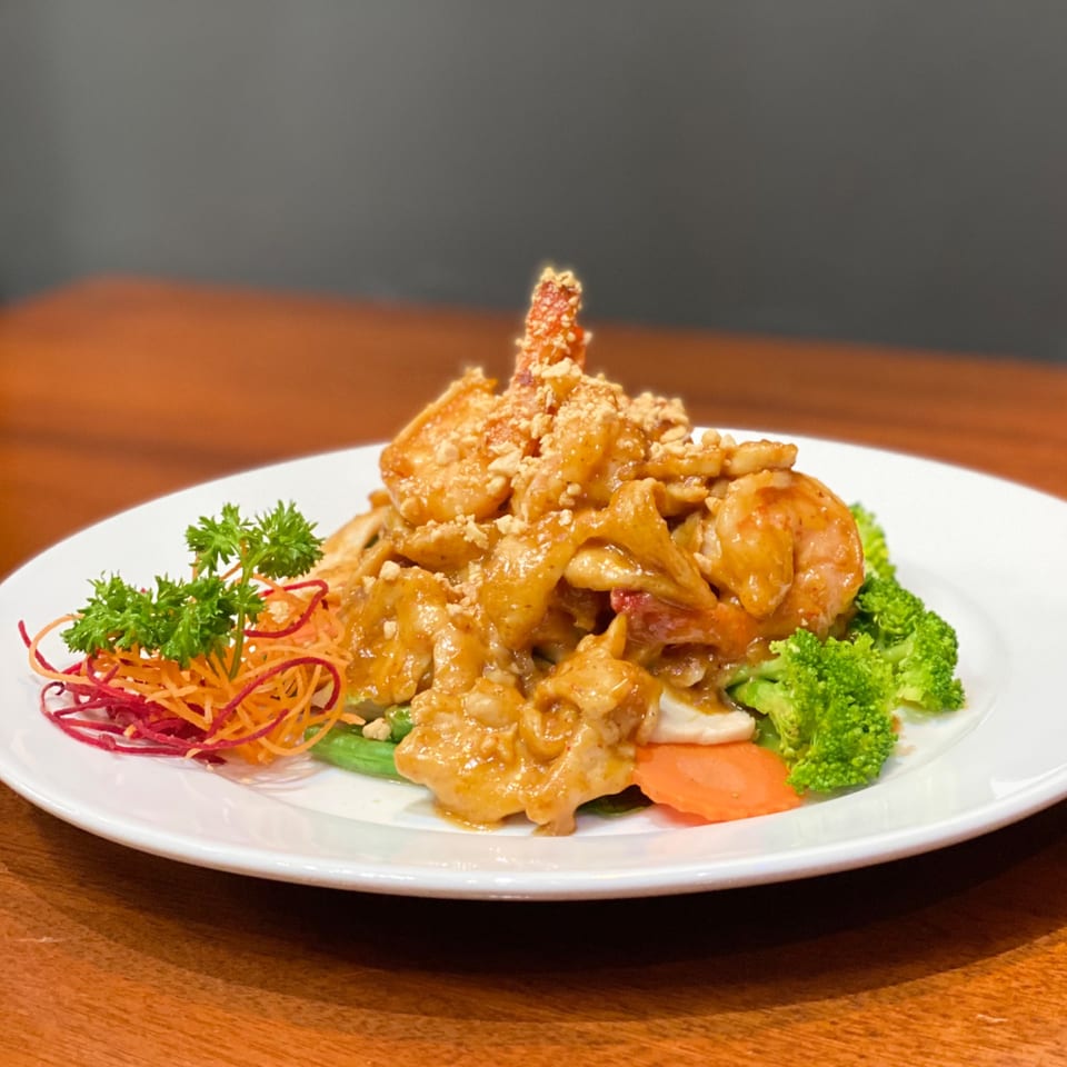 My Black Thai's peanut sauce dish with shrimp, chicken, broccoli, and shredded carrots.