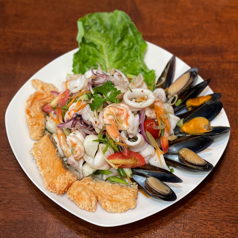 My Black Thai's seafood salad with squid, shrimp, mussels, fried fish, and fresh vegetables.