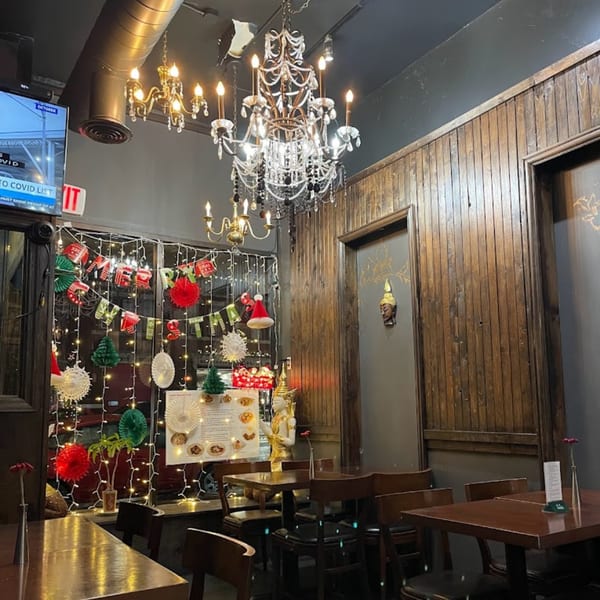 My Black Thai restaurant interior with chandeliers, wooden walls, and festive Christmas decorations.