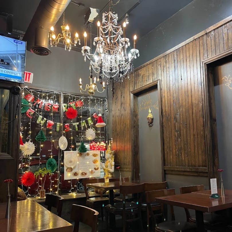 My Black Thai restaurant interior with chandeliers, wooden walls, and festive Christmas decorations.
